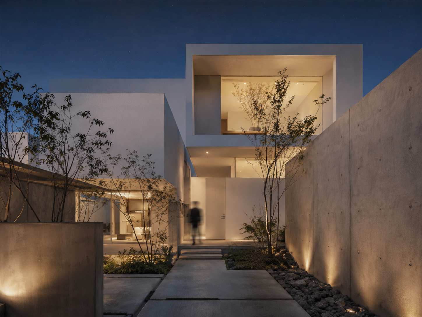 Casa iluminada de noche con muros de hormigón
